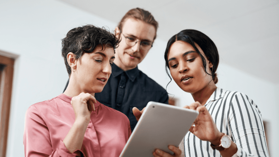 people looking at an Ipad
